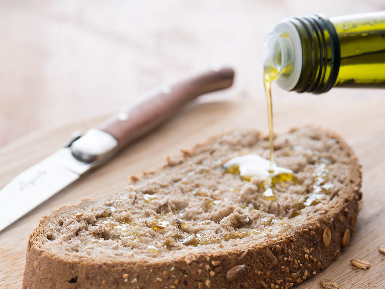 Versata di Olio su fetta di pane integrale